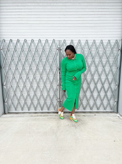 green ribbed maxi dress with a tailored fit, long sleeves, and flowing bell cuffs.”