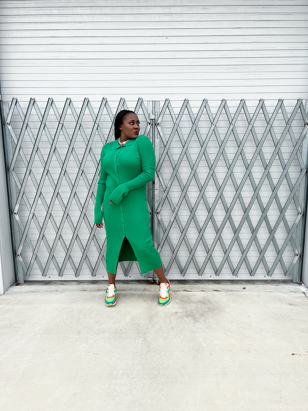 Detailed view of the collared neckline and button-up design on a green ribbed maxi dress for women.