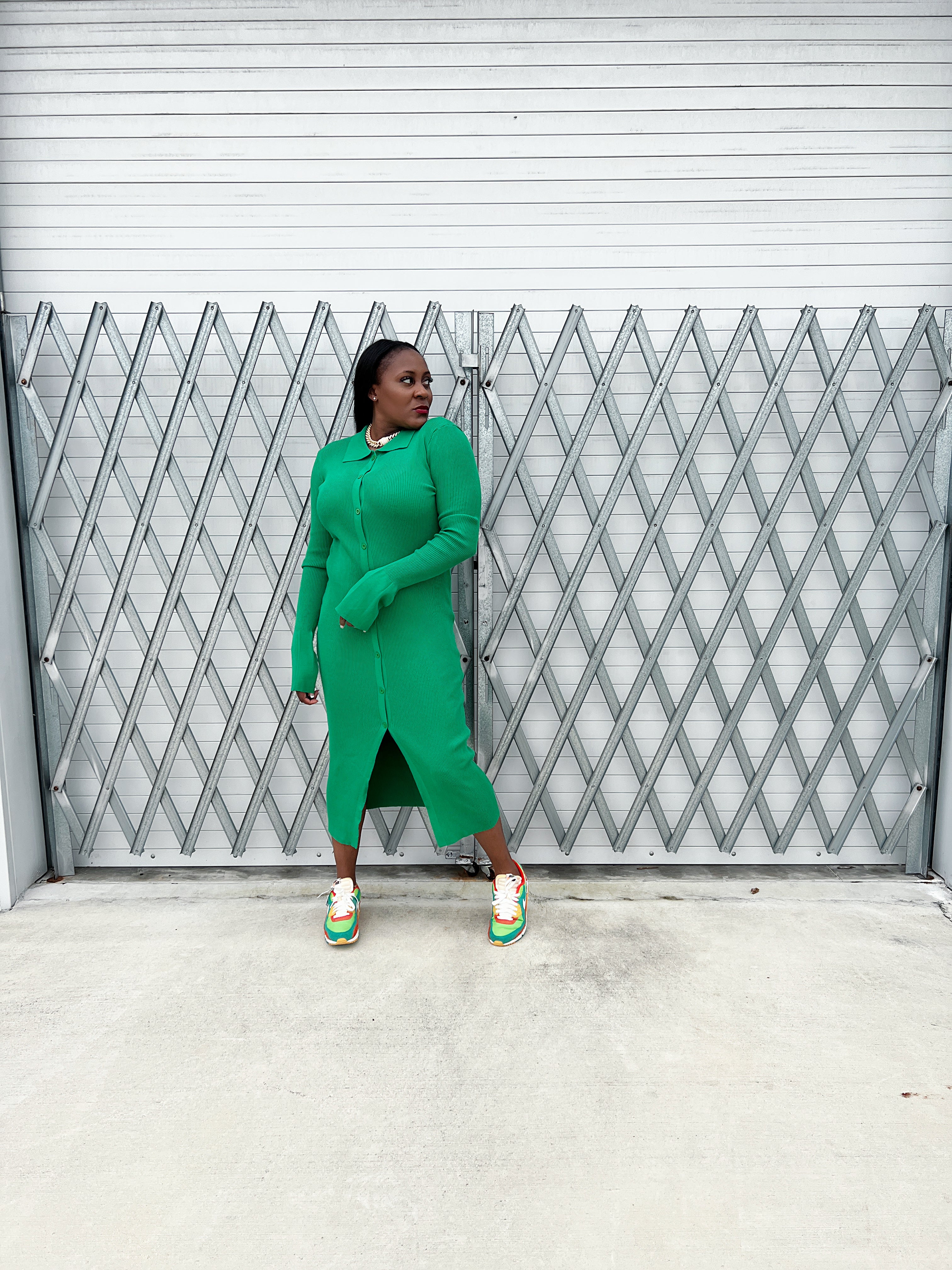 Detailed view of the collared neckline and button-up design on a green ribbed maxi dress for women.