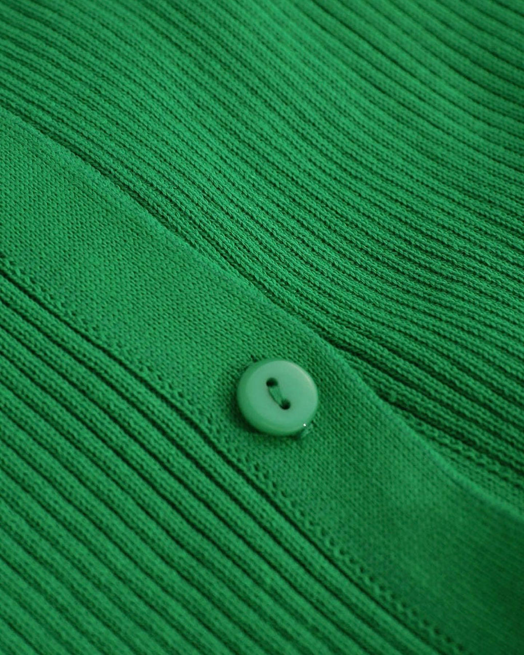 Statement bell sleeves on a ribbed green maxi dress, adding elegance and movement to the design.